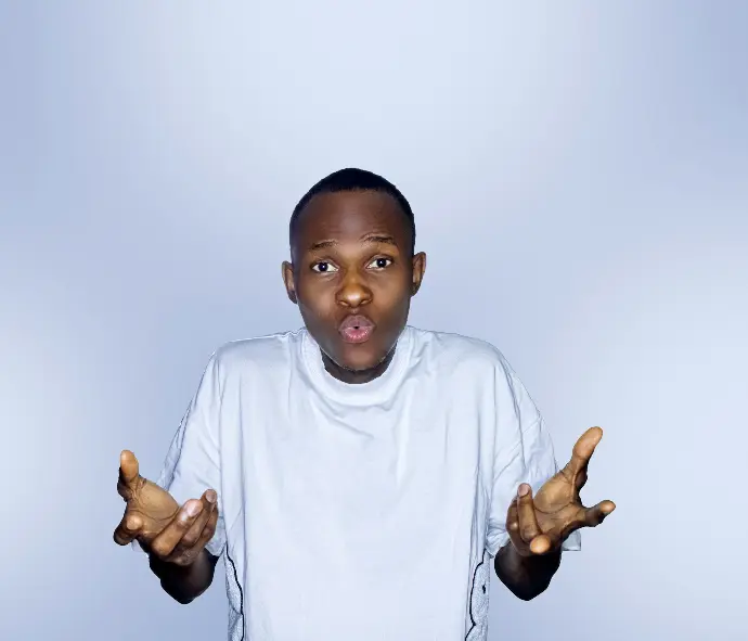 a young boy holding his hands up